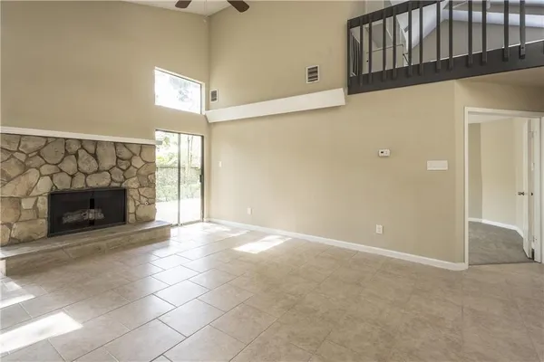 a view of empty room with a fireplace