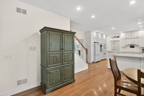 a kitchen with kitchen island a white cabinets and refrigerator