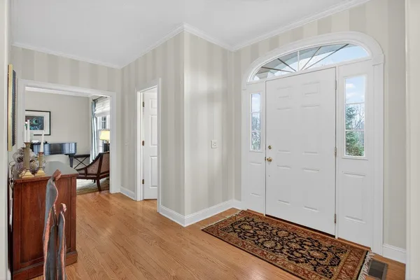 a view of a livingroom and a dining room with wooden floor