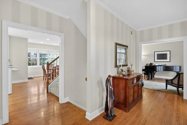 a hallway with wooden floor and furniture