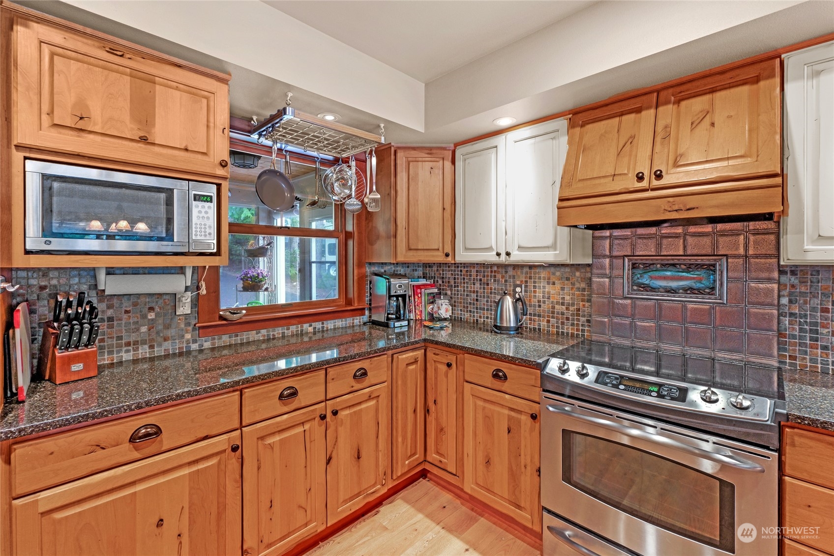160 East Benson Lake Road Grapeview, WA 98546 - Photo 14 of 34 a kitchen with granite countertop cabinets stainless steel appliances and a sink