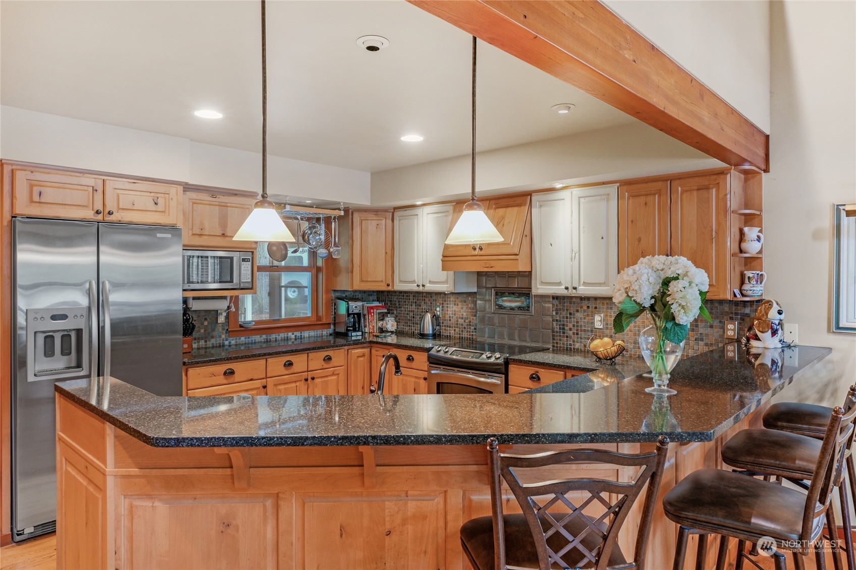 160 East Benson Lake Road Grapeview, WA 98546 - Photo 15 of 34 a kitchen with kitchen island a counter space a sink appliances and cabinets