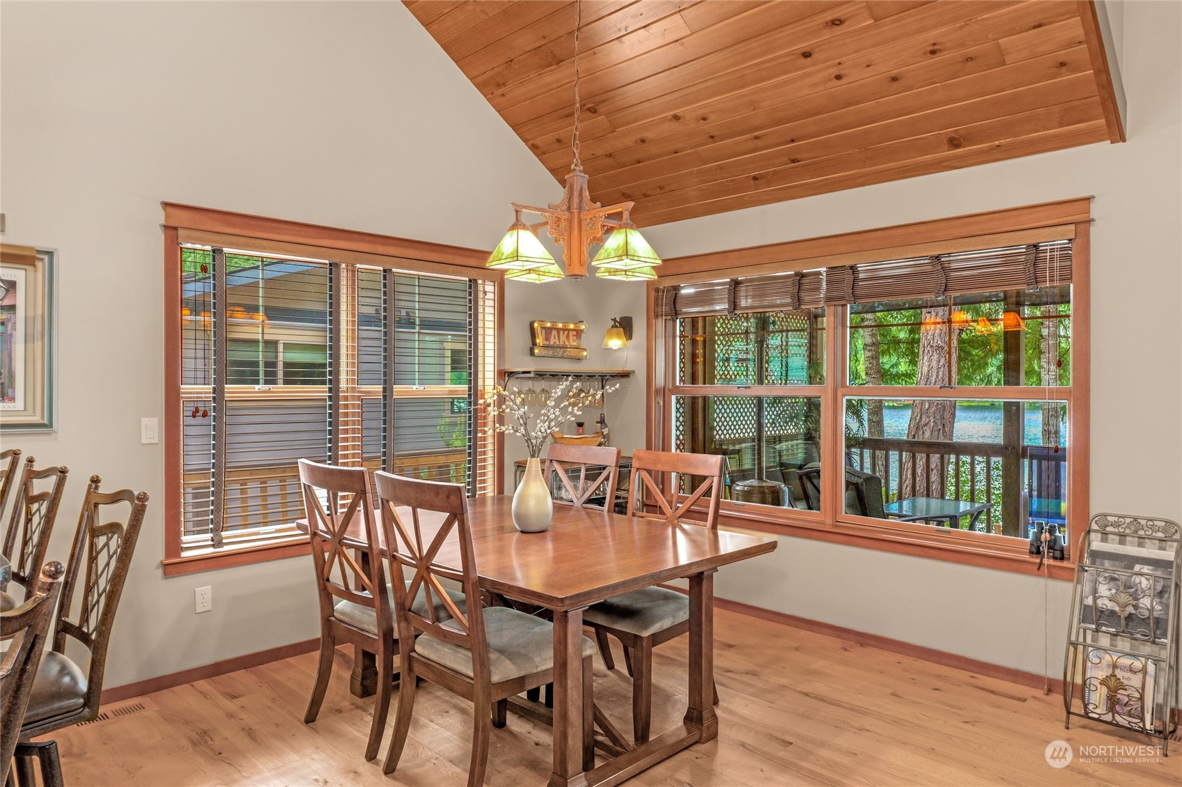 160 East Benson Lake Road Grapeview, WA 98546 - Photo 16 of 34 a view of a dining room with furniture large windows and wooden floor