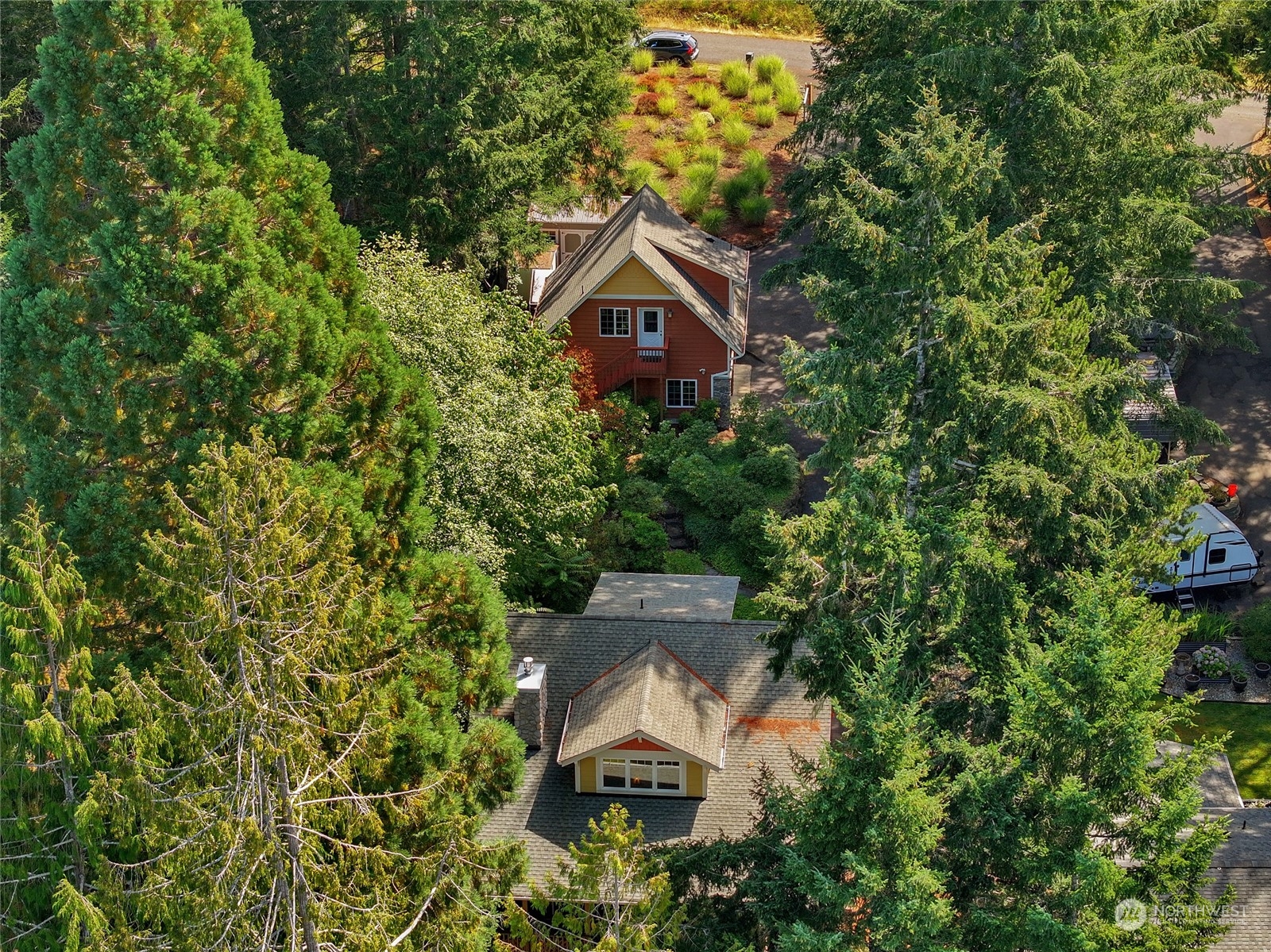 160 East Benson Lake Road Grapeview, WA 98546 - Photo 3 of 34 an aerial view of a house with a yard and large trees
