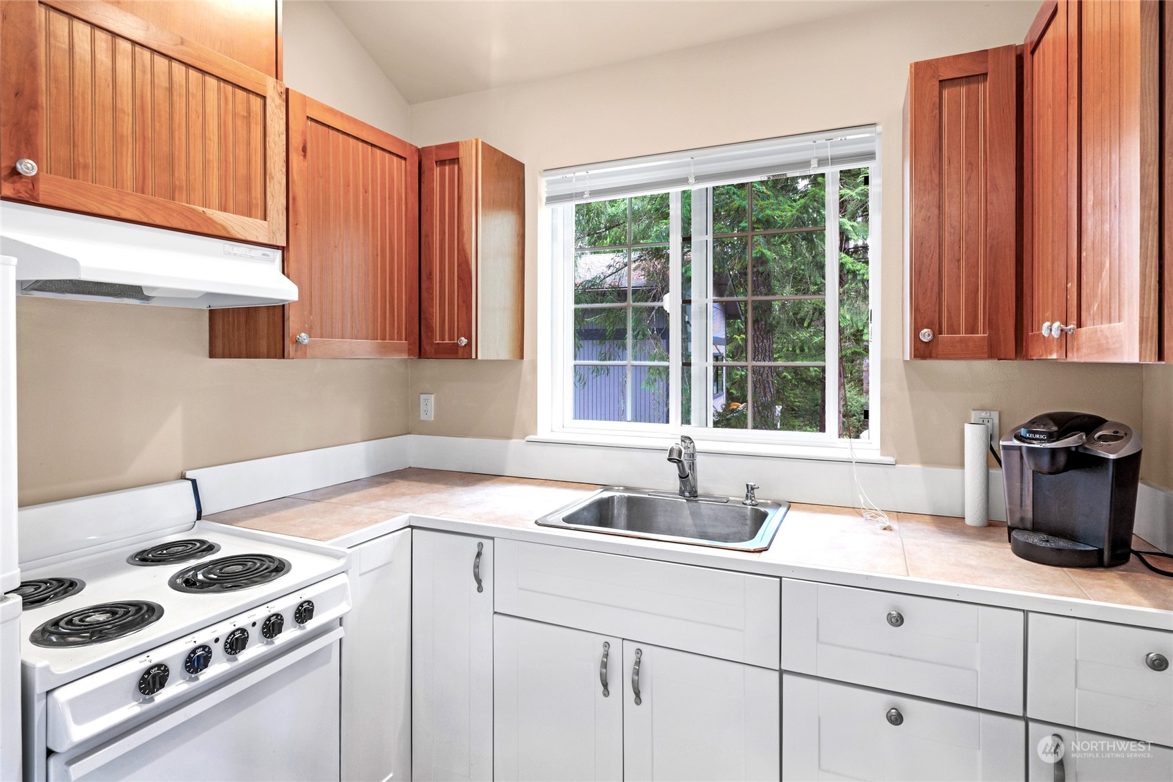 160 East Benson Lake Road Grapeview, WA 98546 - Photo 31 of 34 a kitchen with granite countertop a sink a stove and cabinets