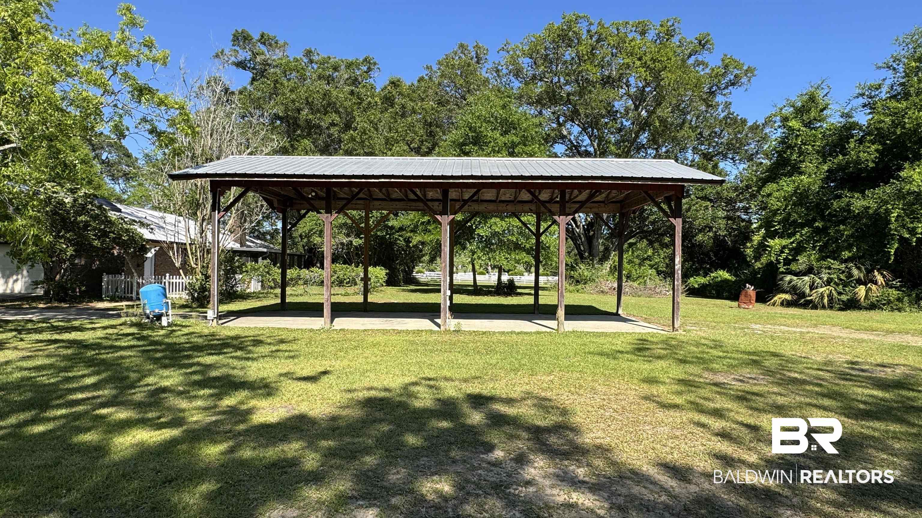 33370 Highway 98 Lillian, AL 36549 - Photo 45 of 58 Expansive outdoor pavilion featuring a metal roof, wood support beams, and a concrete pad