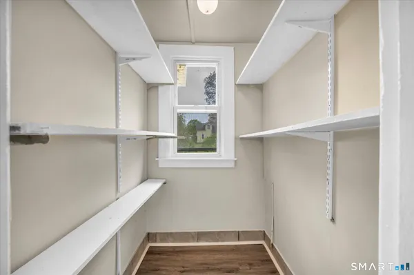 a view of storage and utility room with a window