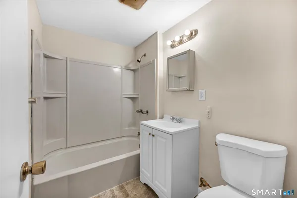 a bathroom with a toilet a sink and bathtub