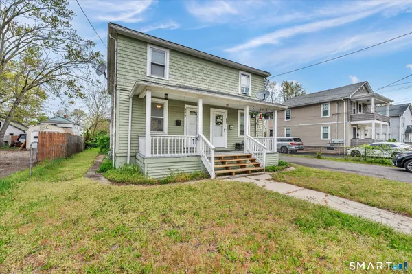 a view of a house with swimming pool and a yard