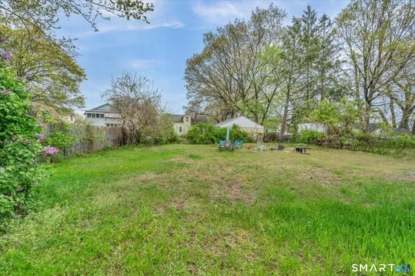 a view of a house with backyard and sitting area