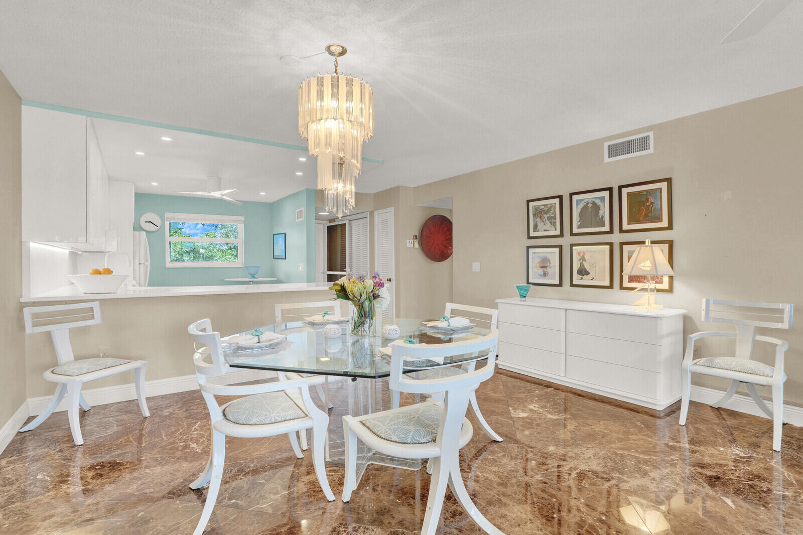 80 Celestial Way, Unit 109 Juno Beach, FL 33408 - Photo 11 of 40 a dining room with chandelier and wooden floor