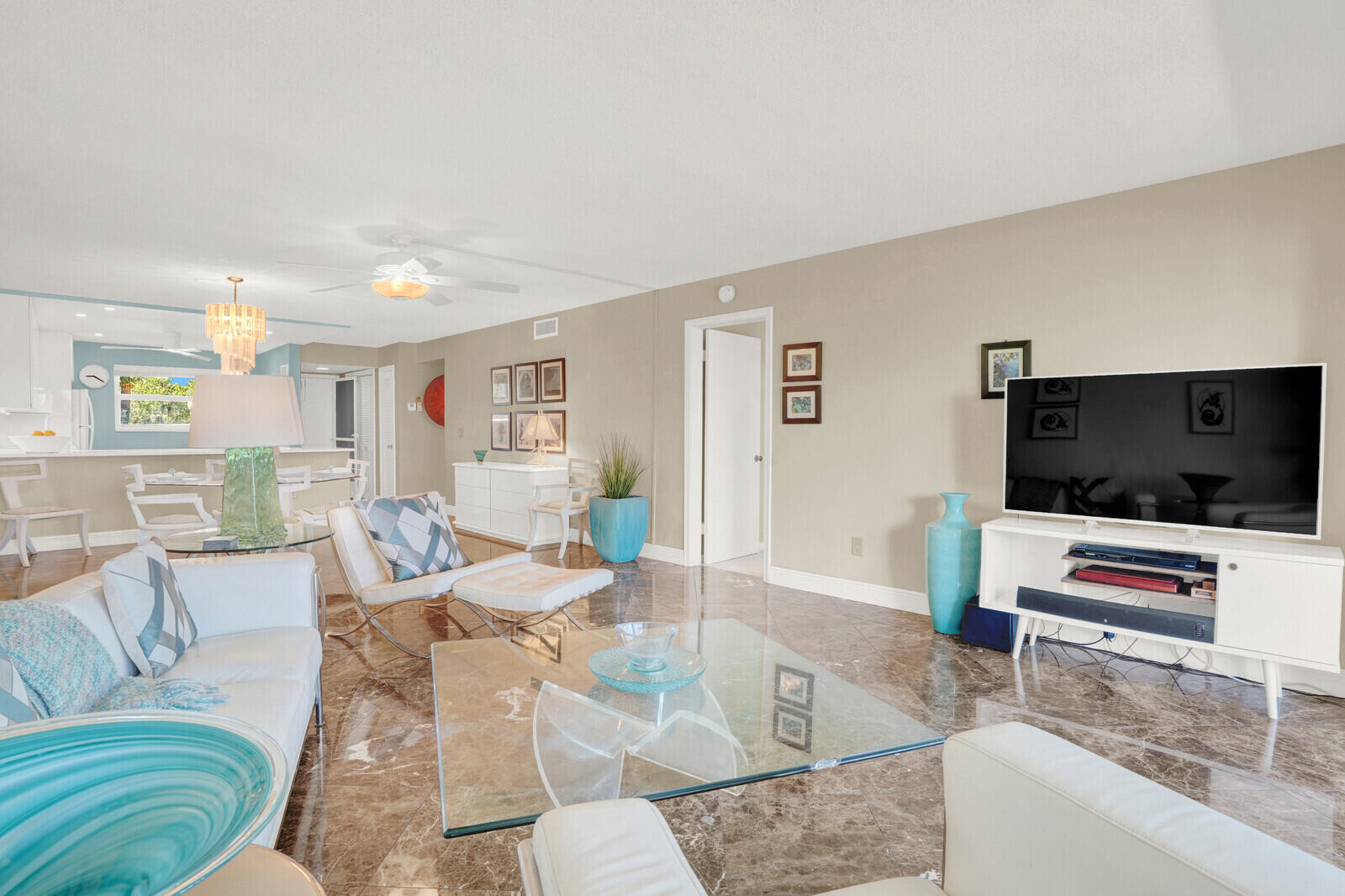 80 Celestial Way, Unit 109 Juno Beach, FL 33408 - Photo 14 of 40 a living room with furniture and a flat screen tv