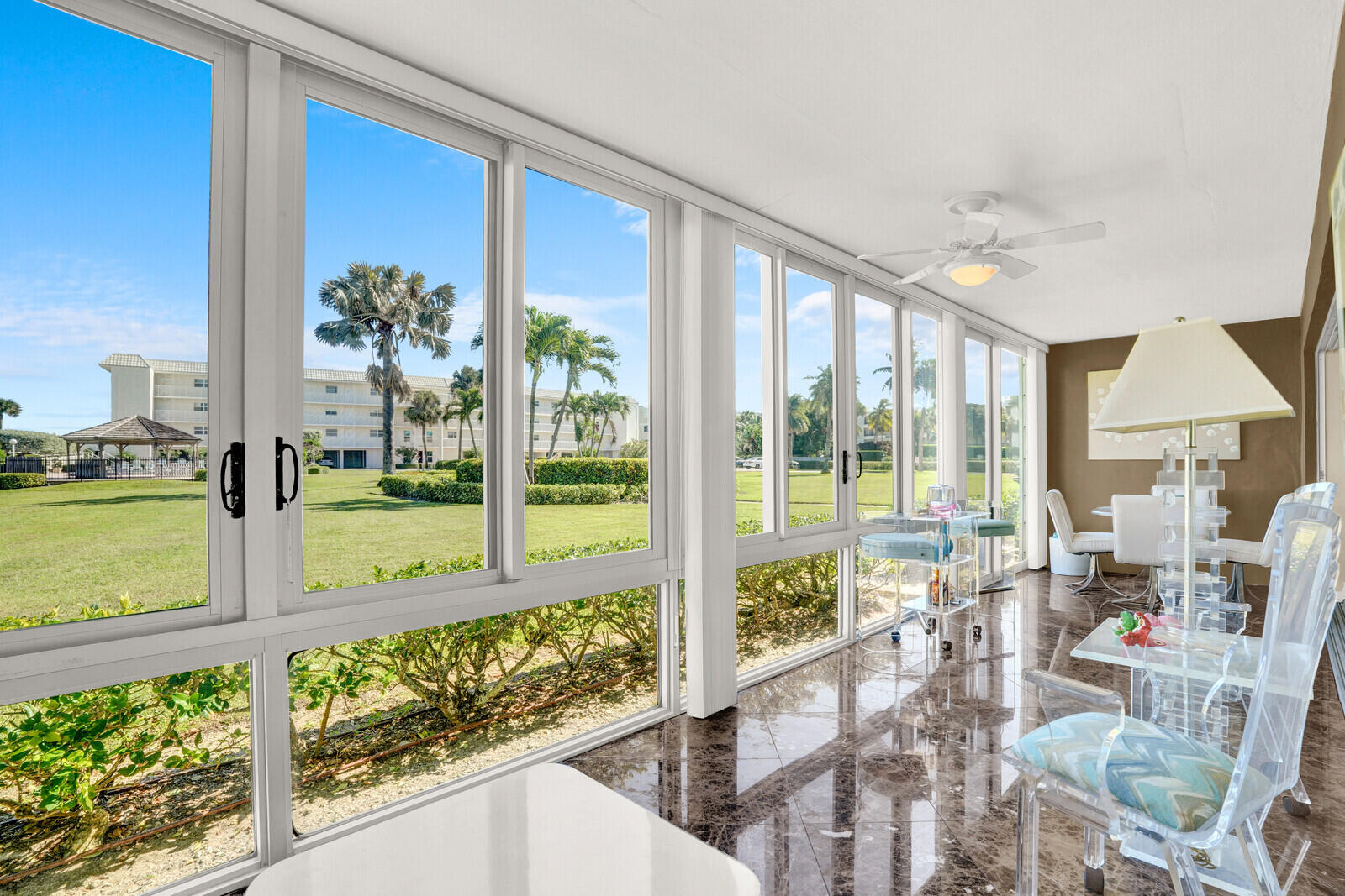 80 Celestial Way, Unit 109 Juno Beach, FL 33408 - Photo 17 of 40 a view of a porch with chairs and backyard