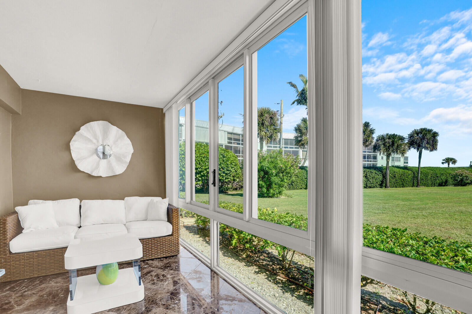 80 Celestial Way, Unit 109 Juno Beach, FL 33408 - Photo 18 of 40 a living room with couch and a large window