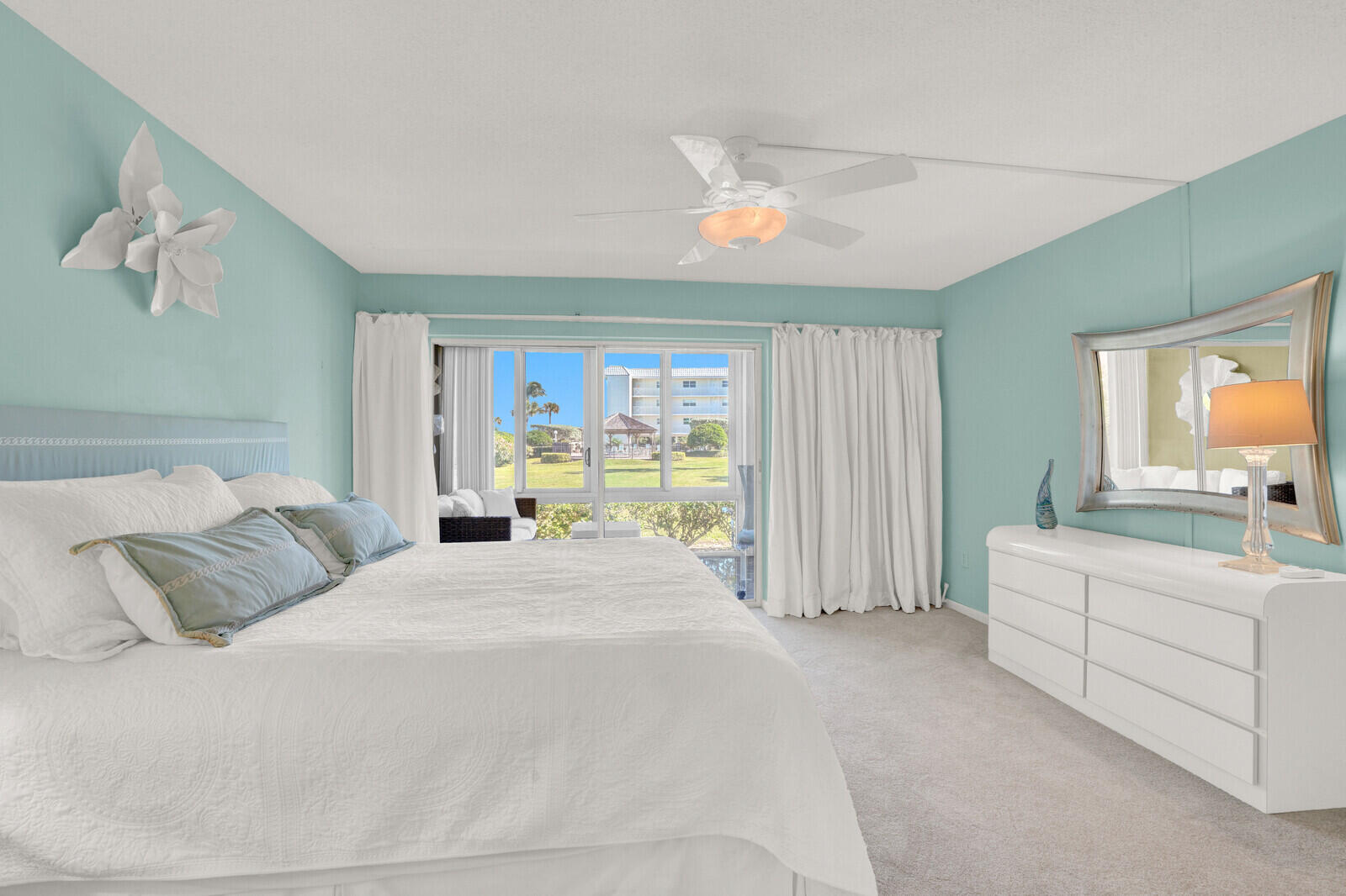 80 Celestial Way, Unit 109 Juno Beach, FL 33408 - Photo 24 of 40 a bedroom with a large bed and a window