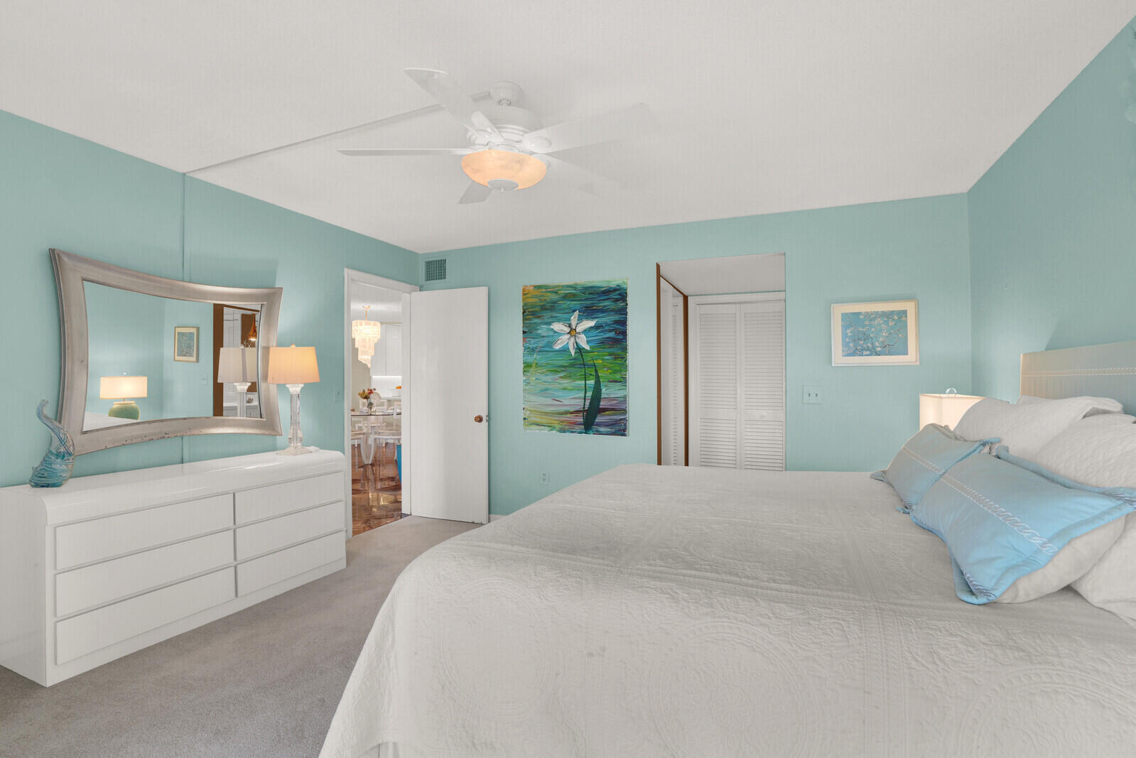 80 Celestial Way, Unit 109 Juno Beach, FL 33408 - Photo 26 of 40 a bedroom with a large bed and a chandelier