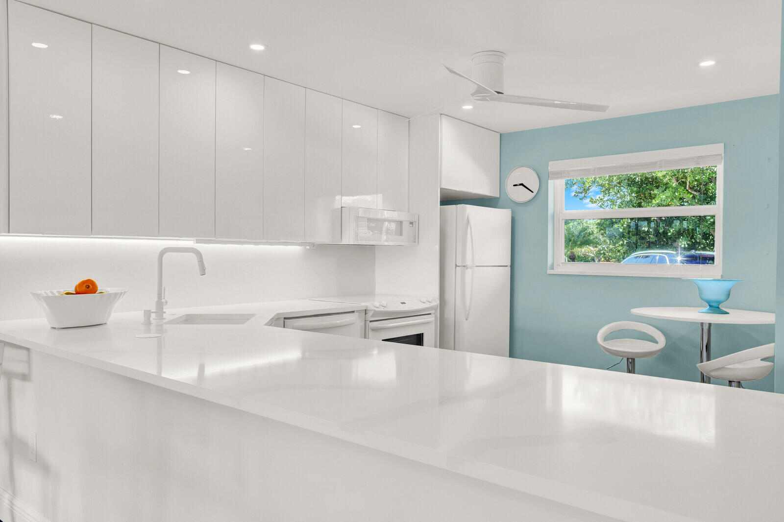 80 Celestial Way, Unit 109 Juno Beach, FL 33408 - Photo 6 of 40 a kitchen with a refrigerator a sink and a stove top oven