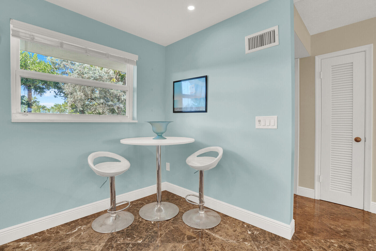 80 Celestial Way, Unit 109 Juno Beach, FL 33408 - Photo 7 of 40 a view of a room with a table and chairs