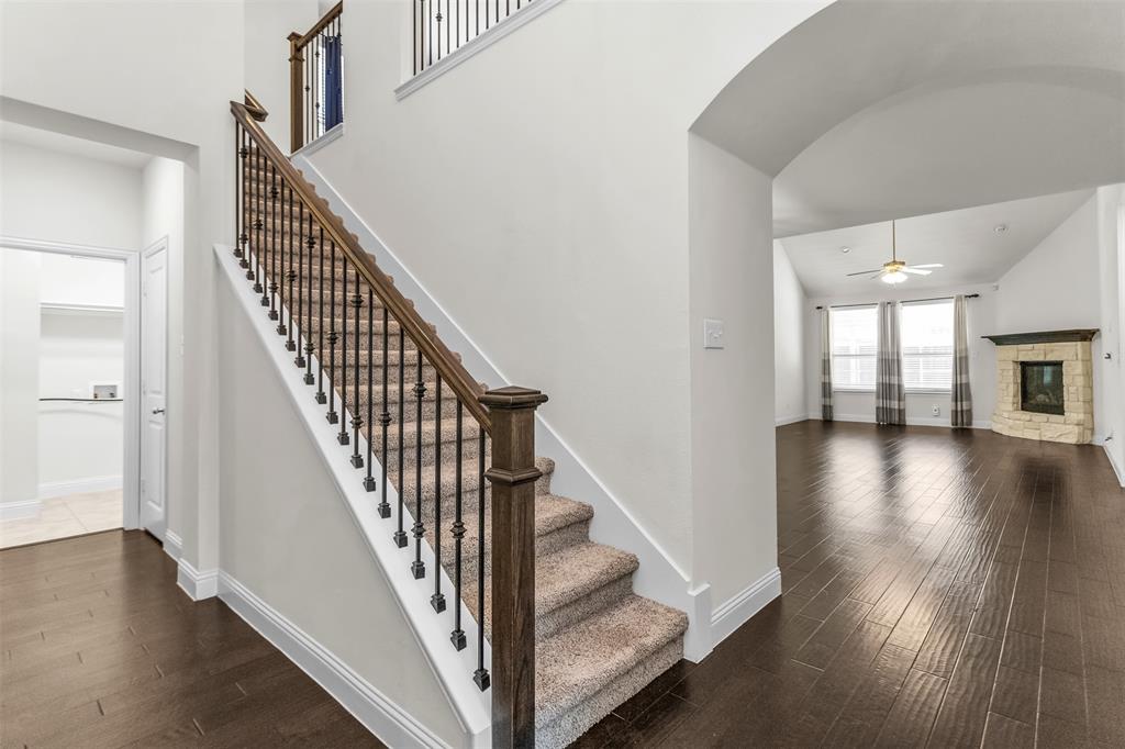 15713 Canyon Ridge Prosper, TX 75078 - Photo 8 of 38 Grand staircase featuring wood railings, wrought iron balusters, and carpeted treads