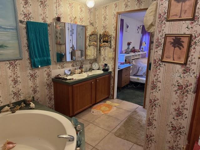 6721 Coronet Road Lakeland, FL 33811 - Photo 28 of 63 a bathroom with a tub sink and mirror