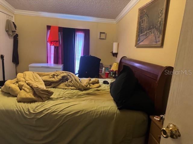 6721 Coronet Road Lakeland, FL 33811 - Photo 33 of 63 a bedroom with a bed and wooden floor