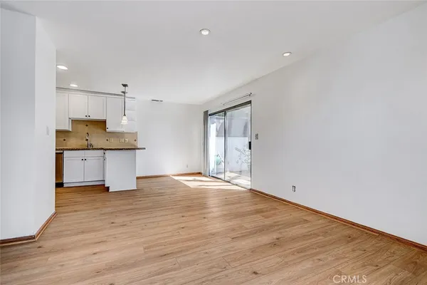 a view of a kitchen with a sink and a refrigerator
