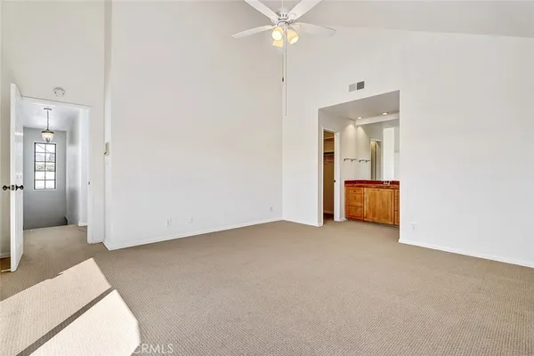 an empty room with fan and entrance