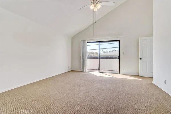 an empty room with chandelier fan