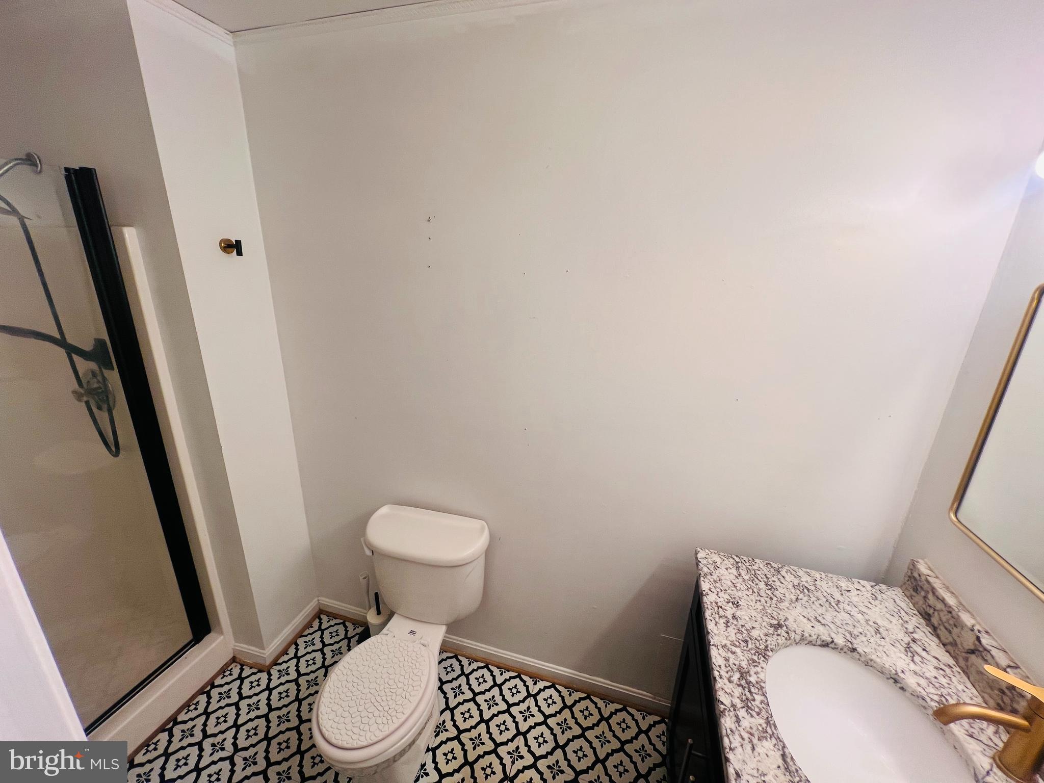 15513 Bealle Hill Road Accokeek, MD 20607 - Photo 20 of 21 a white toilet sitting next to a sink and a mirror