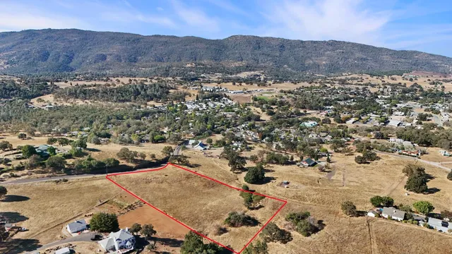 an aerial view of residential house and sandy dunes