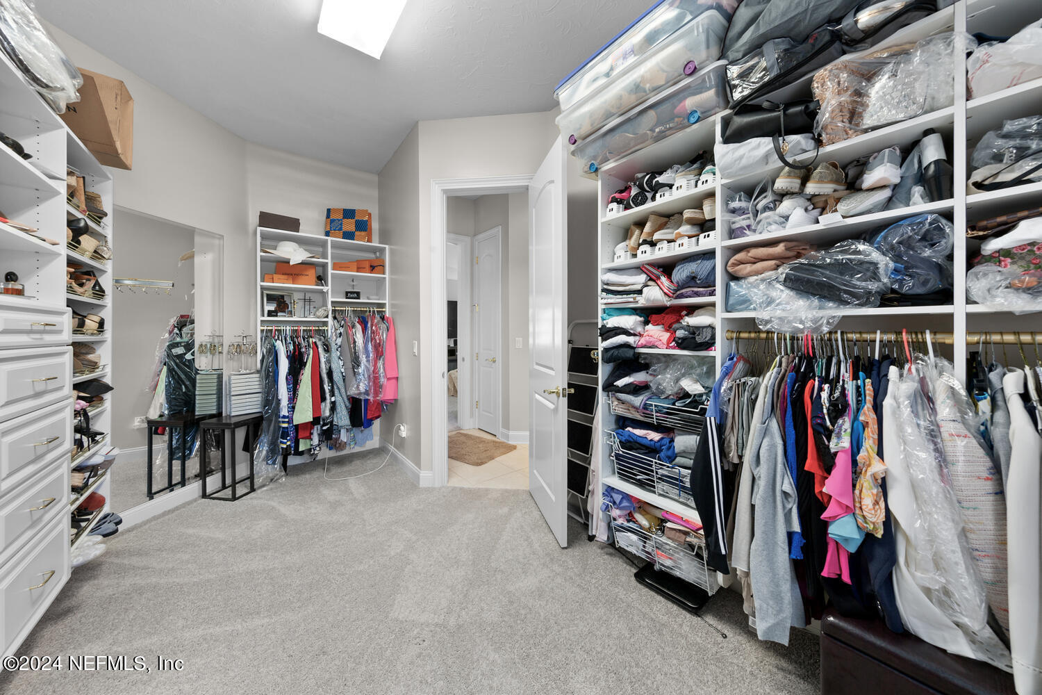 752 Promenade Pointe Drive St. Augustine, FL 32095 - Photo 48 of 117 a view of walk in closet with clothes and shoes