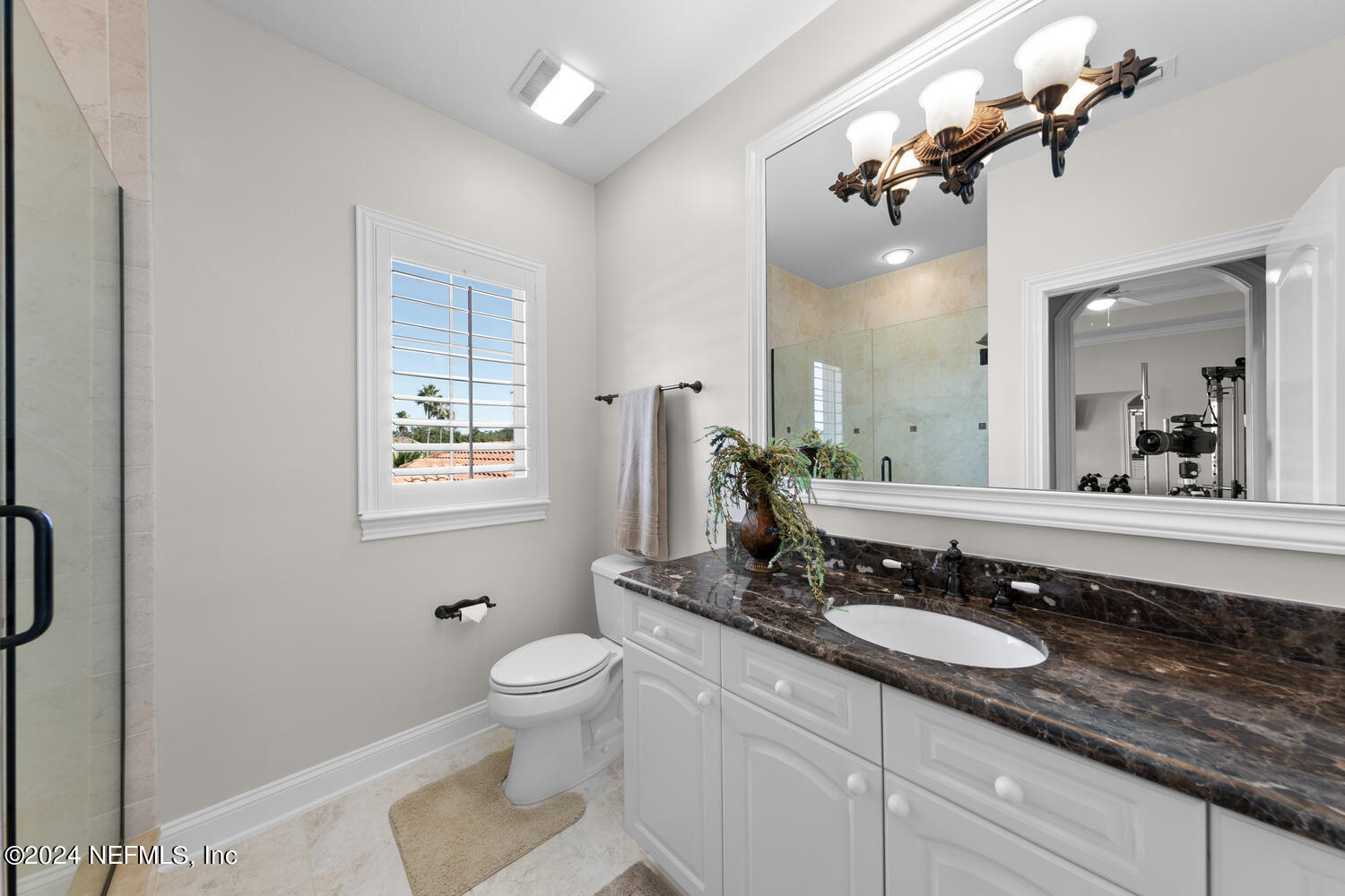 752 Promenade Pointe Drive St. Augustine, FL 32095 - Photo 58 of 117 a bathroom with a granite countertop sink a toilet a mirror and shower