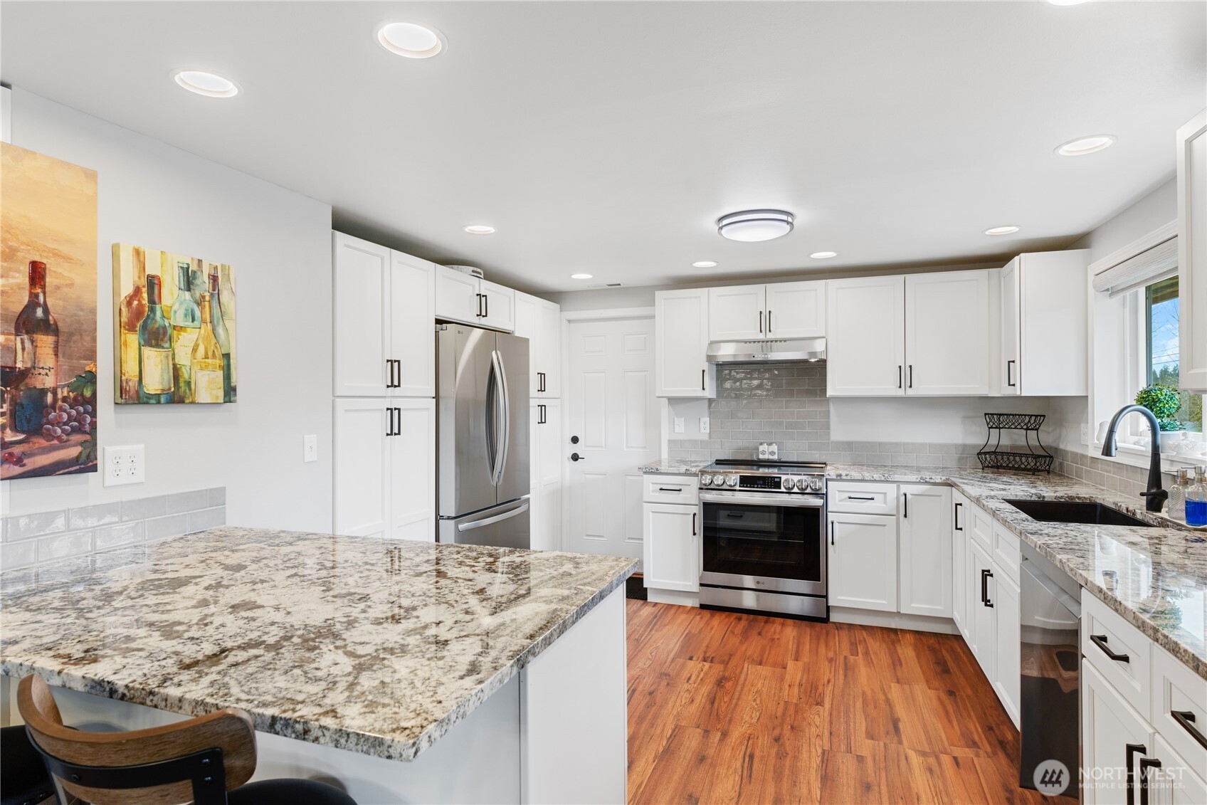 802 Haddon Road Anacortes, WA 98221 - Photo 15 of 36 a kitchen with stainless steel appliances granite countertop a stove and a refrigerator