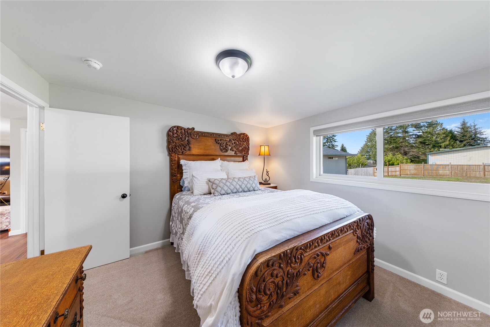 802 Haddon Road Anacortes, WA 98221 - Photo 27 of 36 a bed sitting in a bedroom next to a window