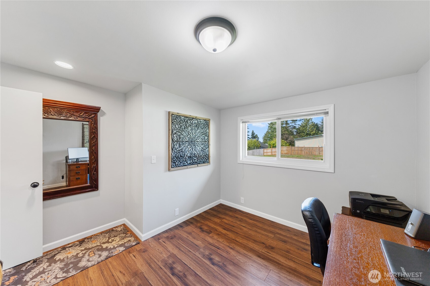 802 Haddon Road Anacortes, WA 98221 - Photo 29 of 36 a view of a livingroom with wooden floor and a ceiling fan