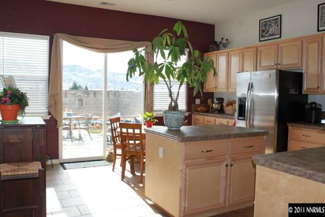 10680 Eagle Falls Way Reno, NV 89521 - Photo 3 of 8 a kitchen with stainless steel appliances a sink a counter top space and a large window