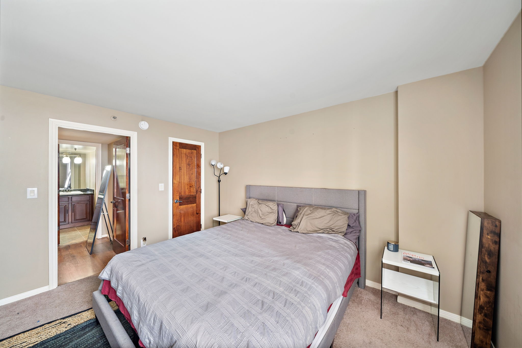 3525 Sage Road, Unit 1111 Houston, TX 77056 - Photo 8 of 18 a bedroom with a bed and wooden floor