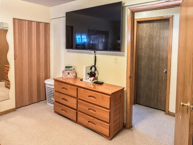 a room with a bed and a mirror