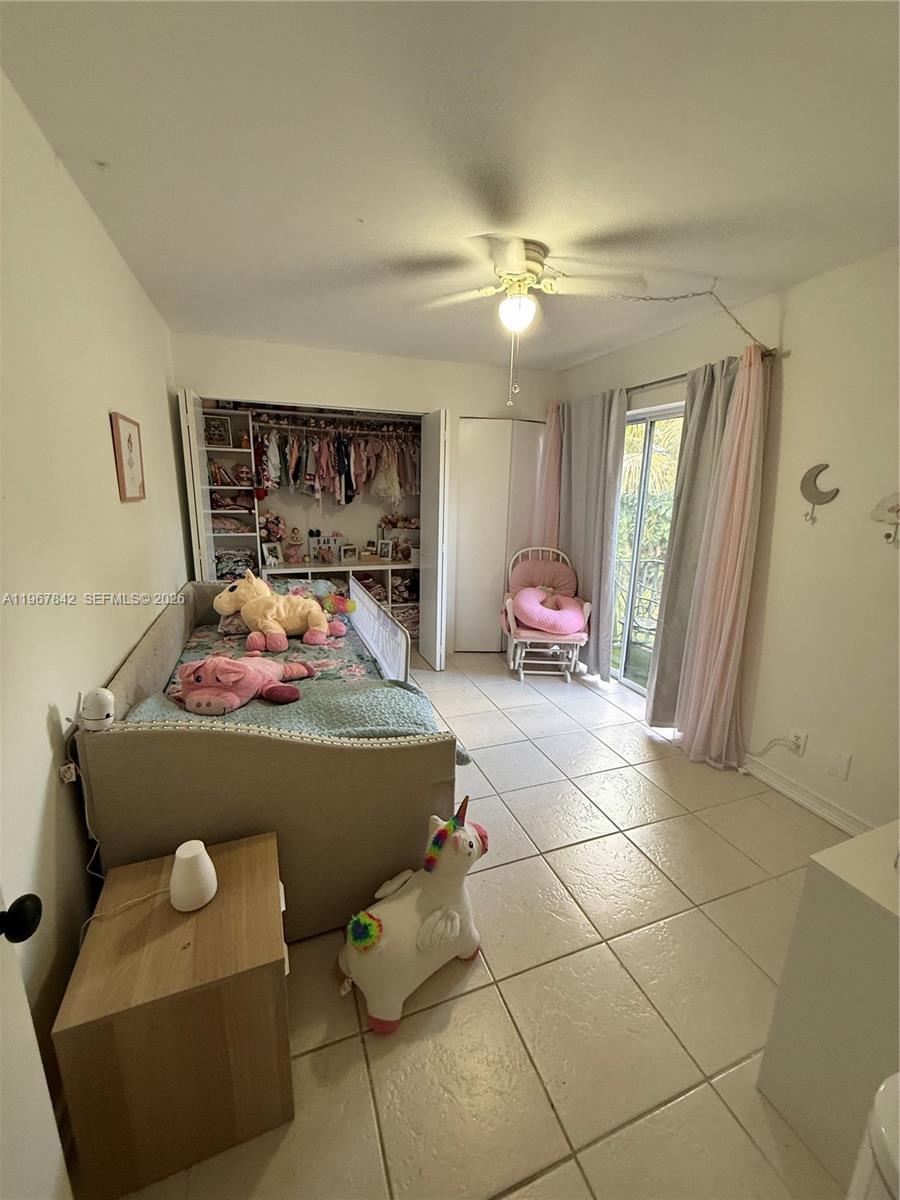 283 Woodland Road, Unit 283 Palm Springs, FL 33461 - Photo 16 of 28 a living room with furniture and a chandelier