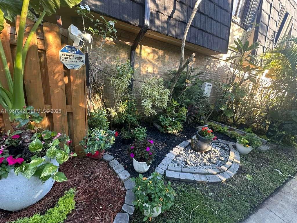 283 Woodland Road, Unit 283 Palm Springs, FL 33461 - Photo 25 of 28 a front view of a house with a yard and outdoor seating