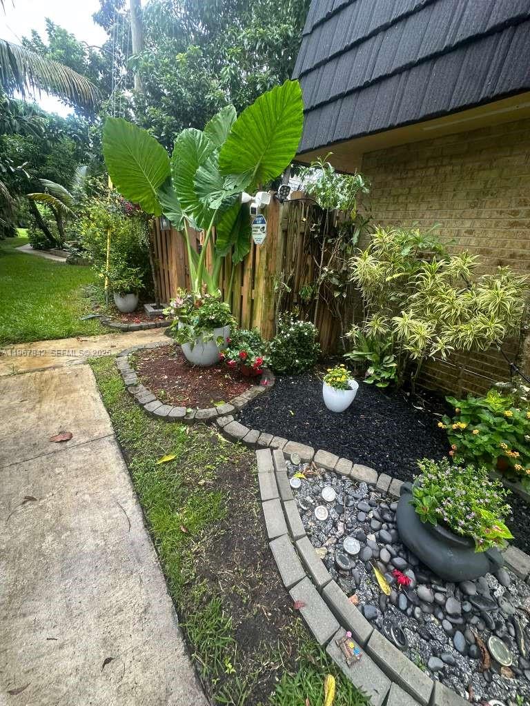 283 Woodland Road, Unit 283 Palm Springs, FL 33461 - Photo 26 of 28 a view of a wooden floor with a flower garden