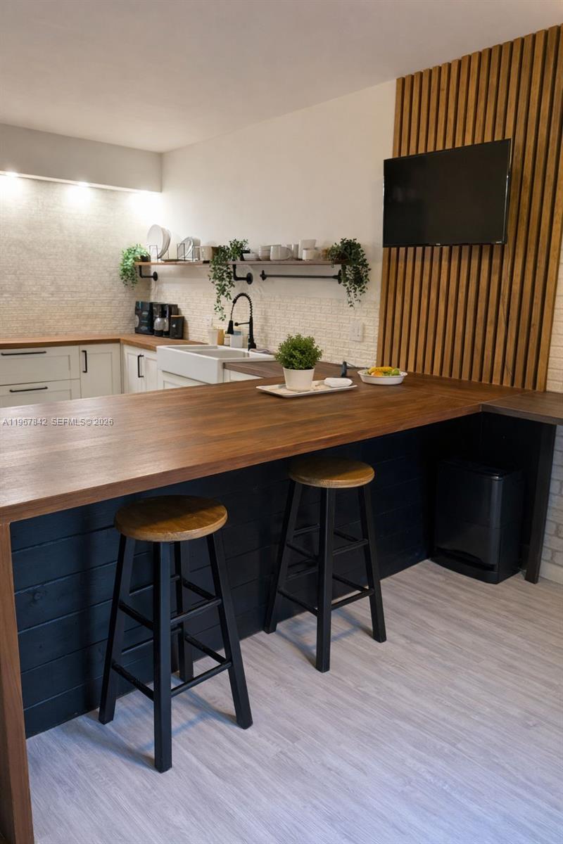 283 Woodland Road, Unit 283 Palm Springs, FL 33461 - Photo 4 of 28 a room with a table chairs and wooden floor