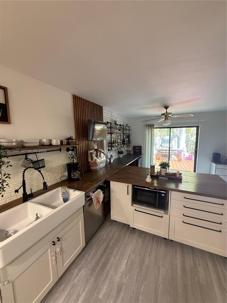 283 Woodland Road, Unit 283 Palm Springs, FL 33461 - Photo 6 of 28 a kitchen with white cabinets and appliances