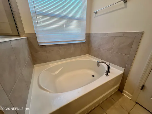 a bathroom with a double vanity sink mirror and toilet
