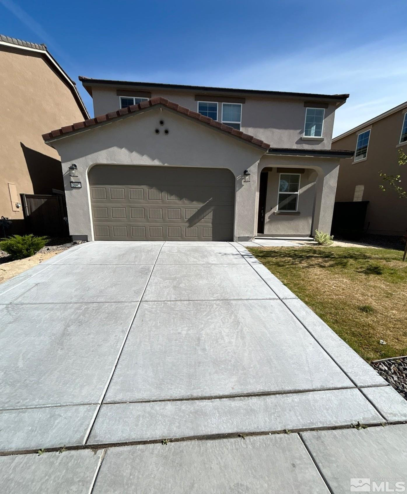 a front view of a house with parking area