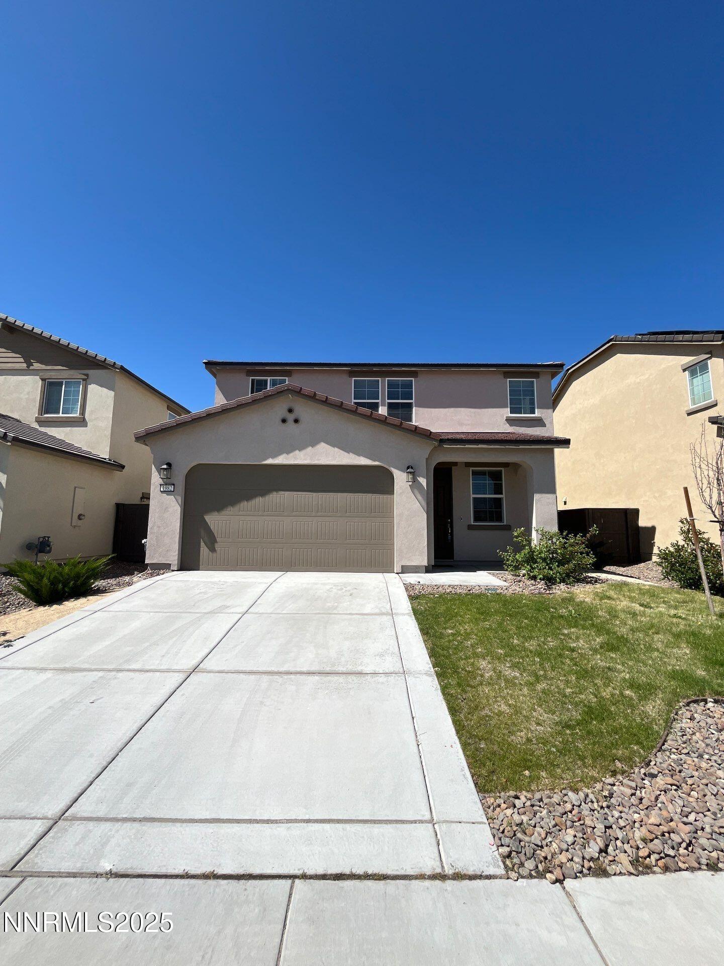 1982 Maradona Drive Sparks, NV 89436 - Photo 3 of 20 a front view of a house with a yard