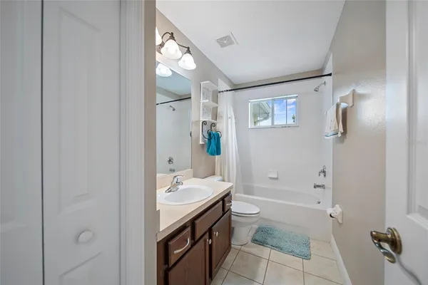 a spacious bathroom with a granite countertop sink a toilet and shower