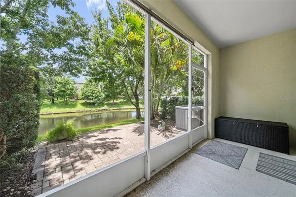 a view of a balcony with lake view and a floor to ceiling window