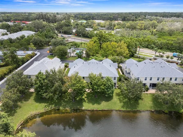 an aerial view of residential houses with outdoor space and swimming pool