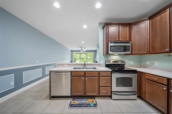 a kitchen with stainless steel appliances granite countertop a stove sink and microwave